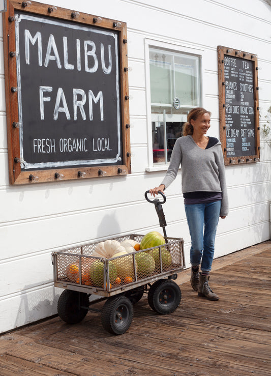 Helene owner of Malibu Farm in front of a white building